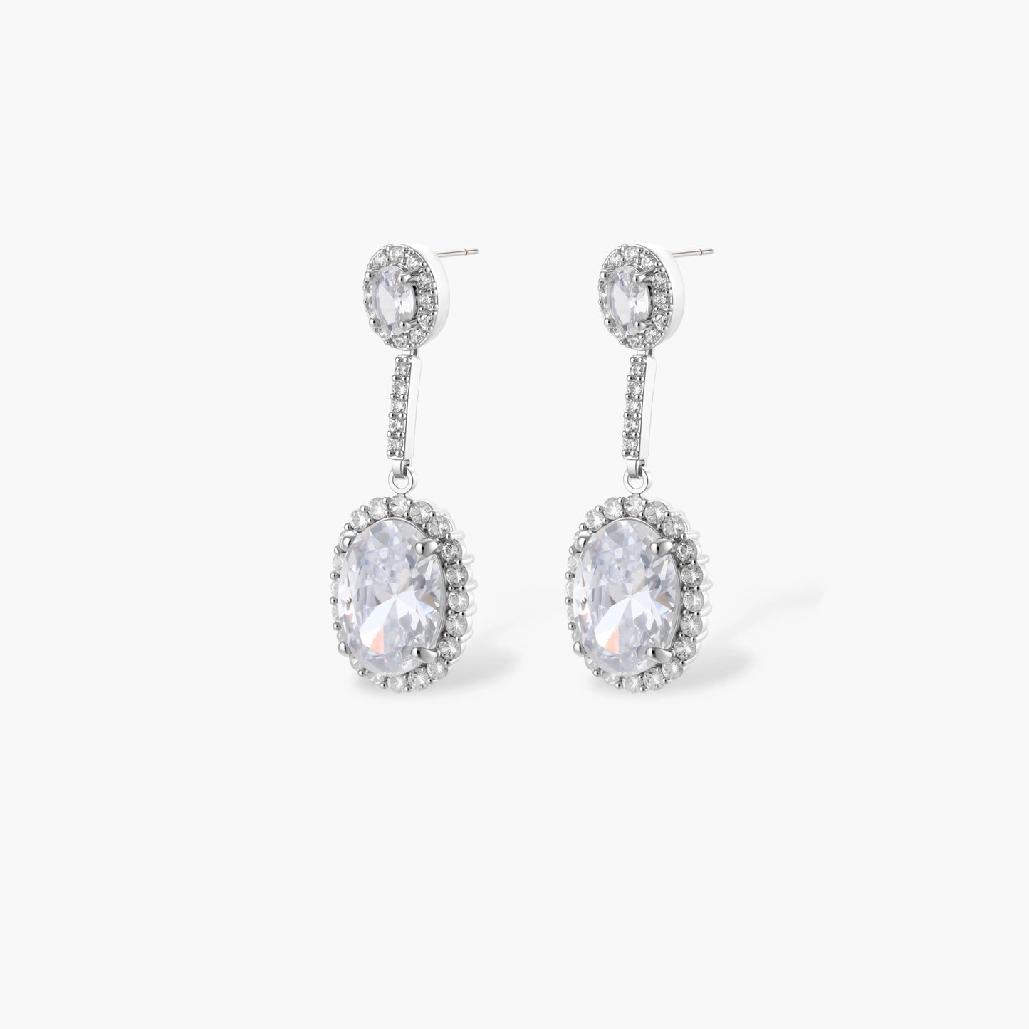 Elegant white gold plated jewelry set with oval cubic zirconia stones in halo settings, featuring Y-necklace and drop earrings.
