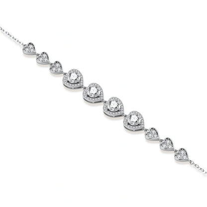 Sterling silver bracelet with graduated heart-shaped links and sparkling moissanite stones in VVS1 clarity on white background.