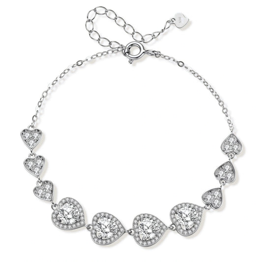 Sterling silver bracelet with graduated heart-shaped links and sparkling moissanite stones in VVS1 clarity on white background.