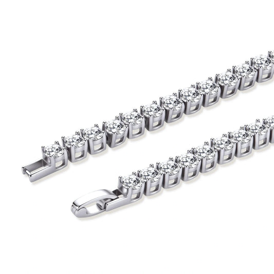 Sterling silver tennis bracelet with continuous row of brilliant moissanite stones and secure clasp closure on cream background.
