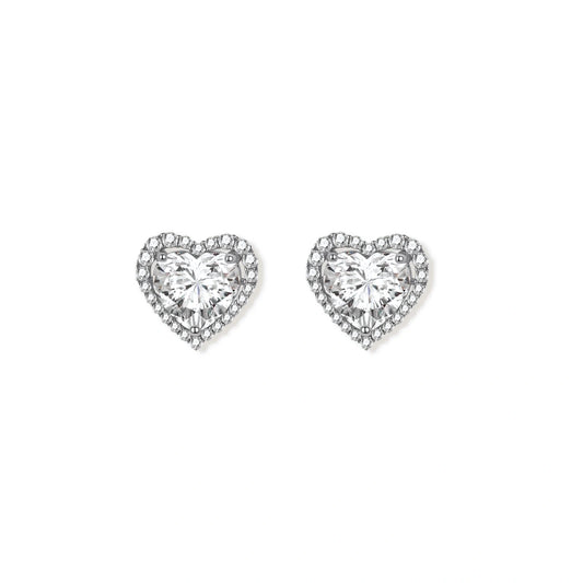 Close-up of heart-shaped moissanite stud earrings in sterling silver halo setting on cream background.