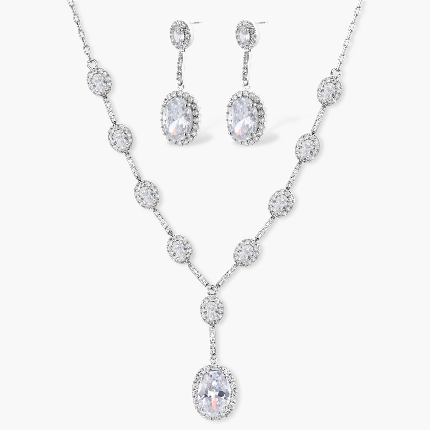 Elegant white gold plated jewelry set with oval cubic zirconia stones in halo settings, featuring Y-necklace and drop earrings.