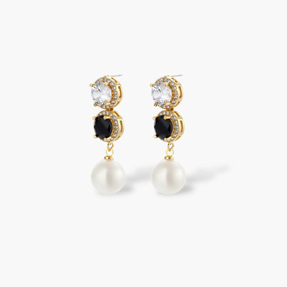 Gold-plated jewelry set with alternating black and clear cubic zirconia stones, featuring necklace, earrings and bracelet