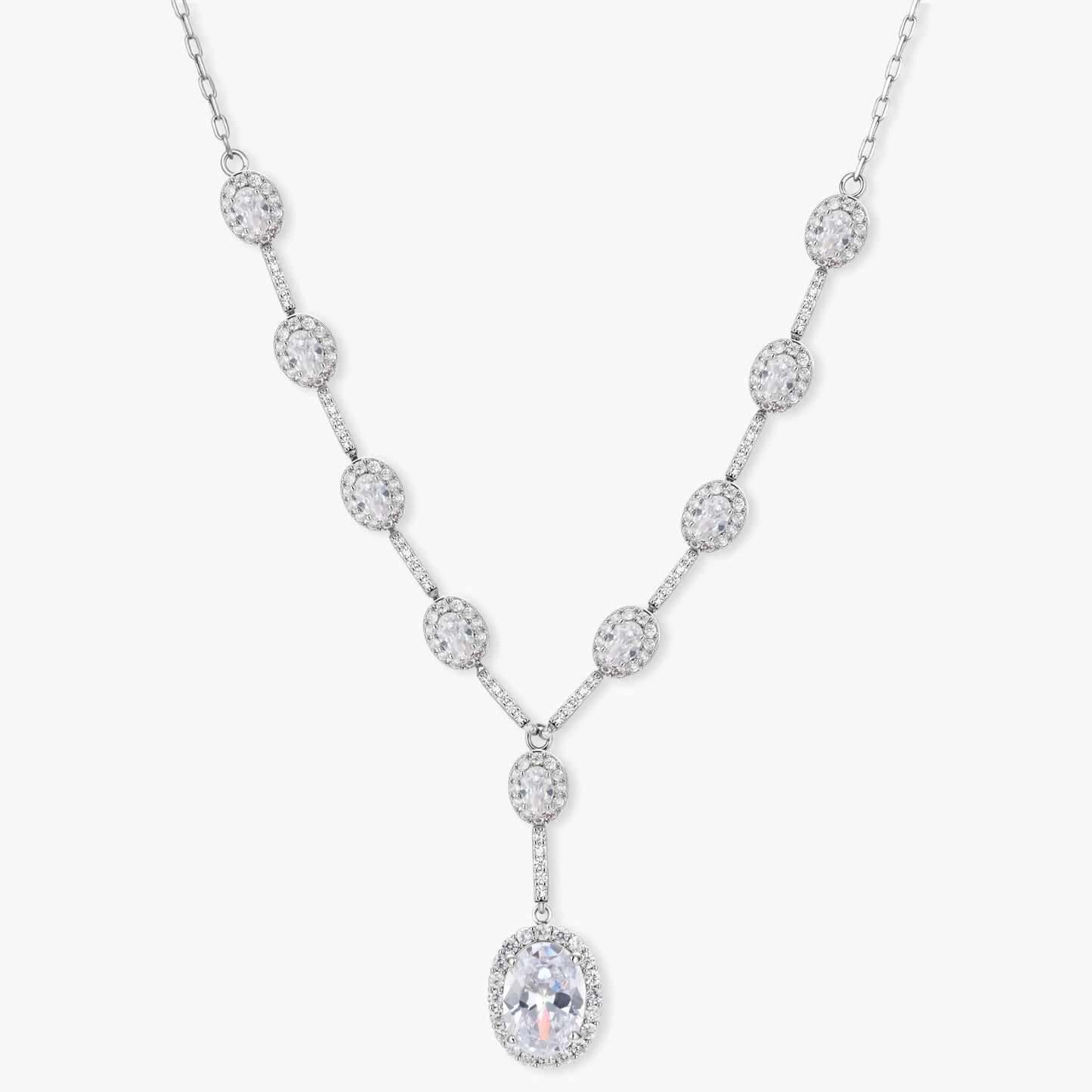Elegant white gold plated jewelry set with oval cubic zirconia stones in halo settings, featuring Y-necklace and drop earrings.